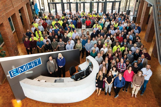 EMH&T employees fill the lobby of the company’s headquarters near New Albany. Behind the desk are President Sandy Doyle-Ahern (right) and executive vice president and chief operating officer Doug Romer.